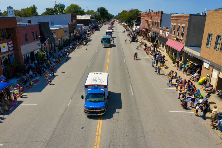 Vibrant aerial photo of a parade with crowds lining the streets in Plainview, MN.
