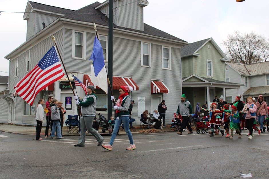 A lively holiday parade with participants carrying flags in Lancaster, Ohio.