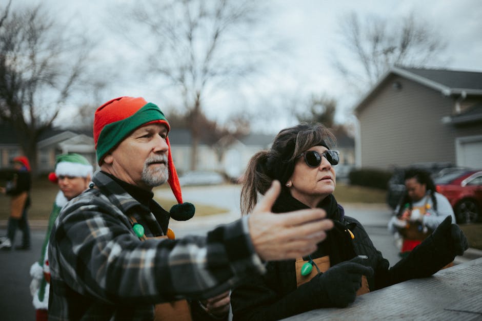 Volunteers in Christmas costumes organizing a holiday event outdoors in winter.