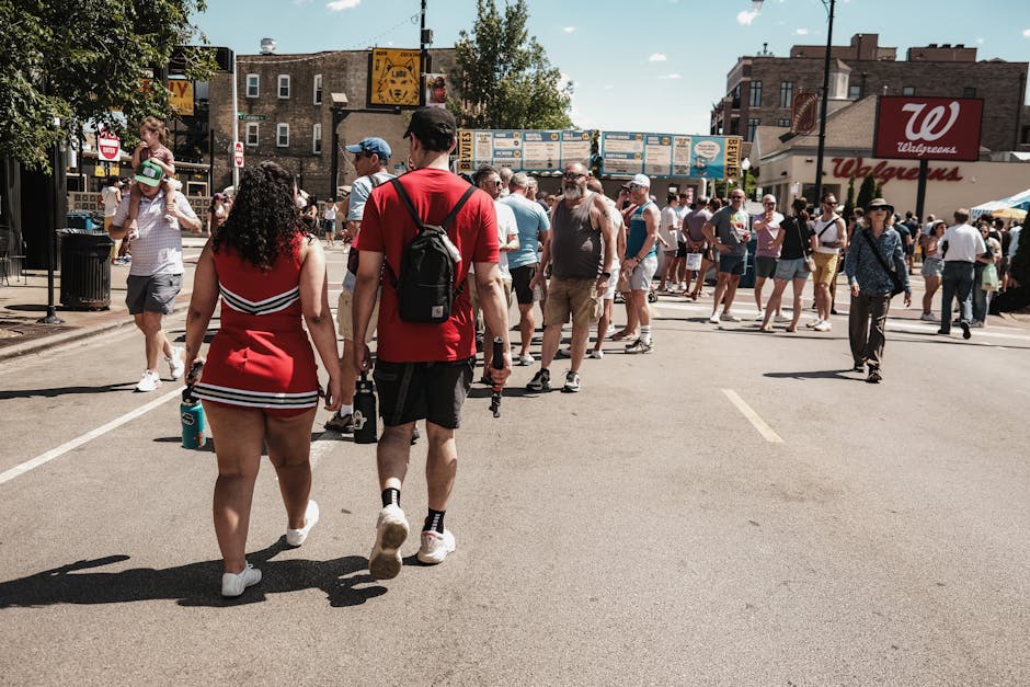 People enjoying a sunlit street event in Chicago, IL. Capture of urban life with a lively crowd.