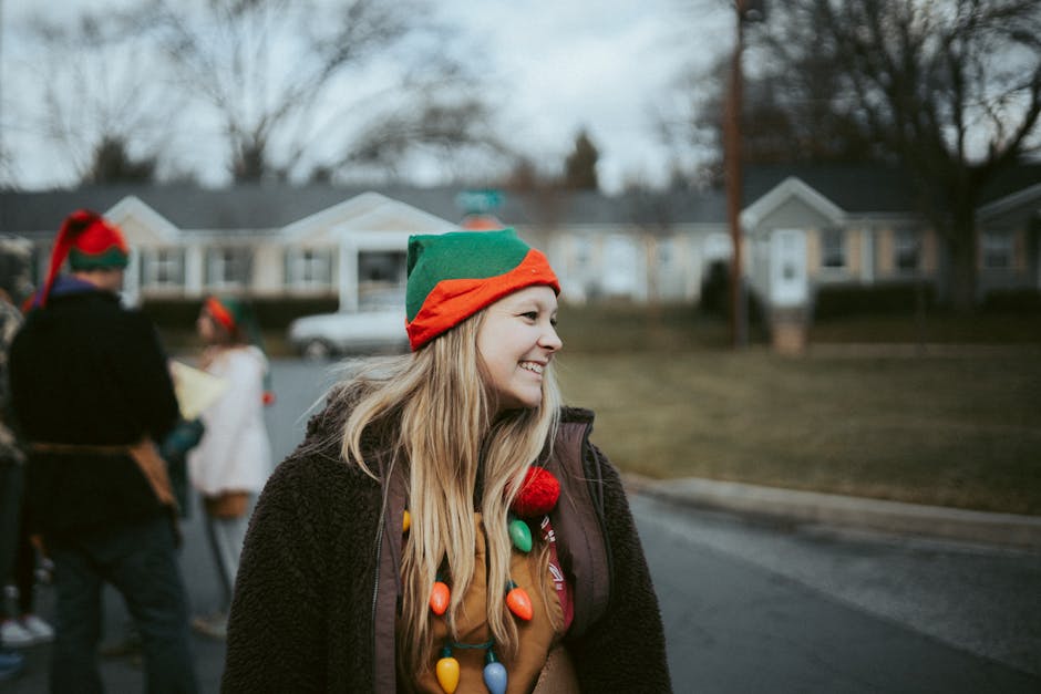 Smiling young woman in elf costume enjoying a festive outdoor event.